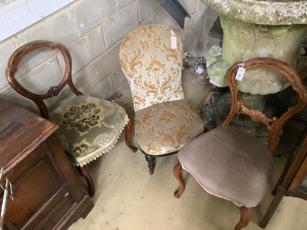 A Victorian ebonised and gilt upholstered nursing chair and pair of balloon back chairs